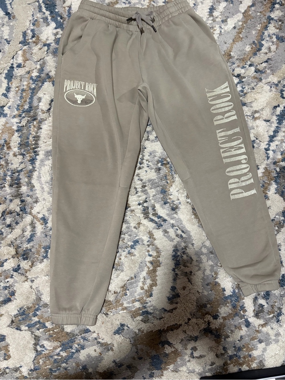 Under Armour Light Gray Joggers with PROJECT ROCK Side Print.